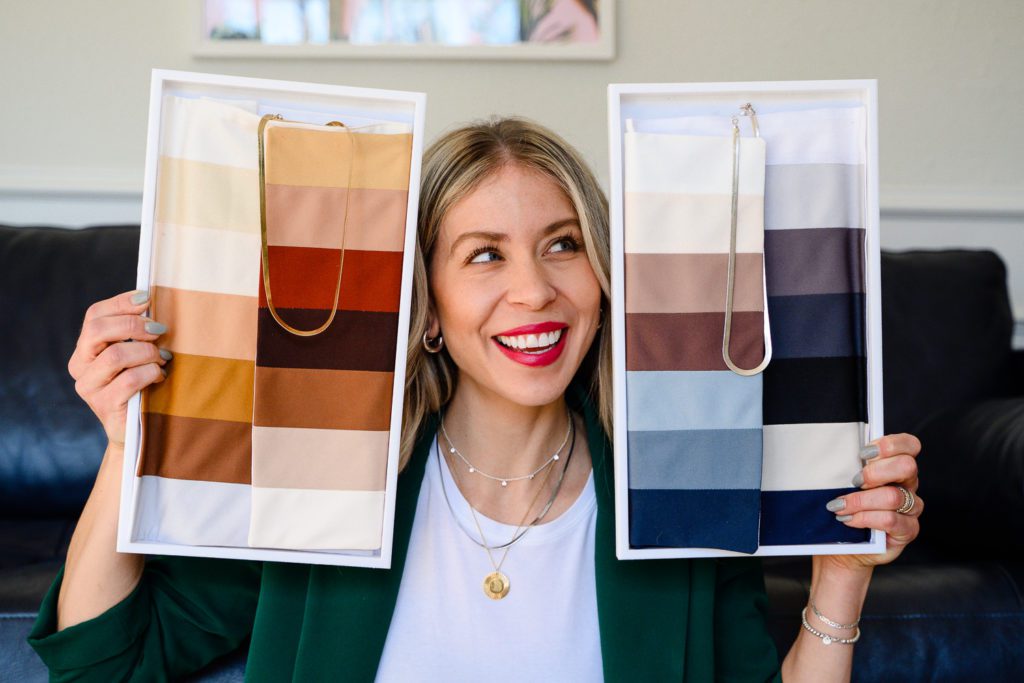 A woman looking at two sets of color swatches during her Denver Branding photos by Denver commercial photographers
