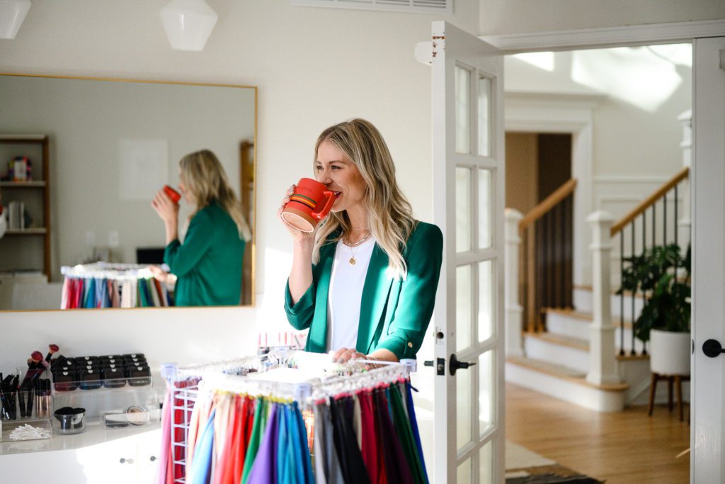 A woman sipping coffee while standing in her studio for her Denver Commercial Photos