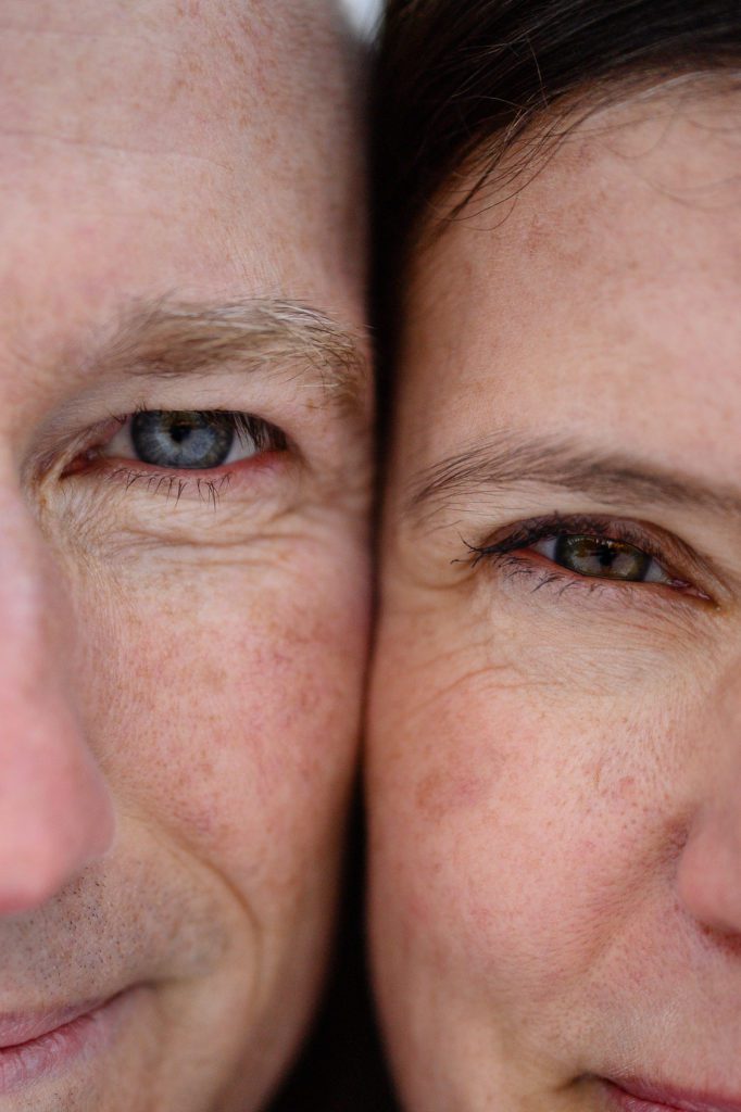 A closeup of a man's blue eyes and a woman's hazel eyes