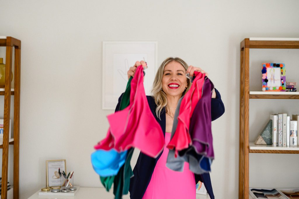 A woman throwing colored scarves at Denver commercial photographers for her branding photos.