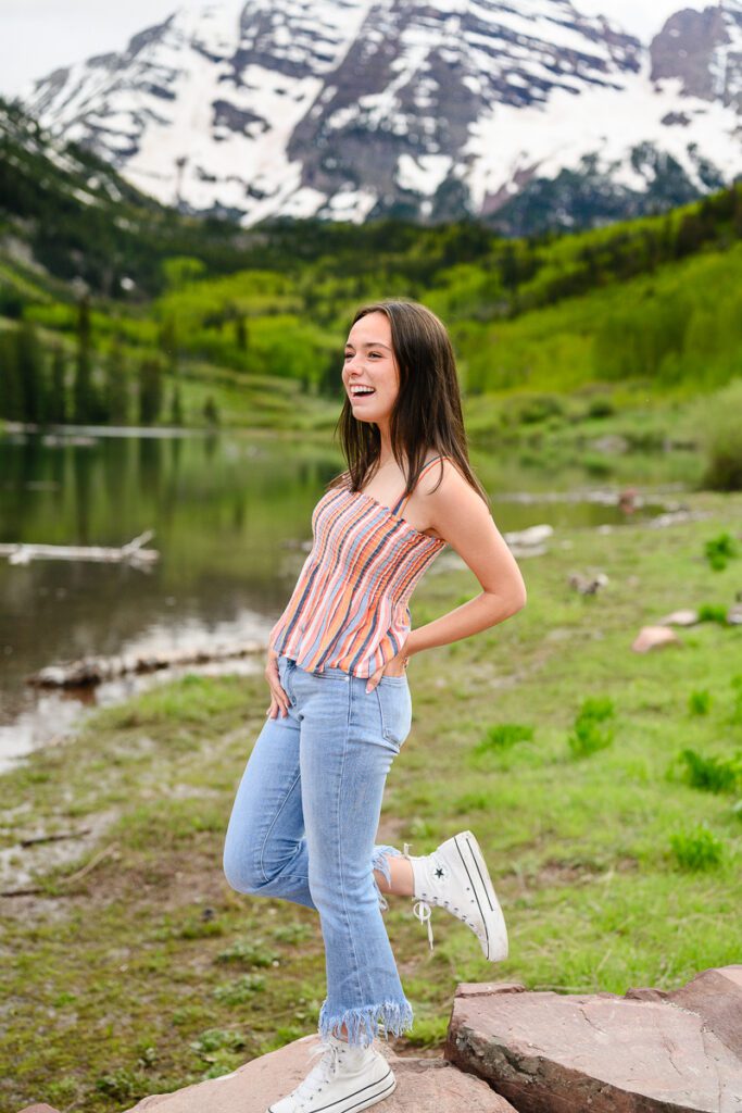 A senior girl at the Maroon Bells in Aspen Colorado posing for her Colorado Mountain senior photographer