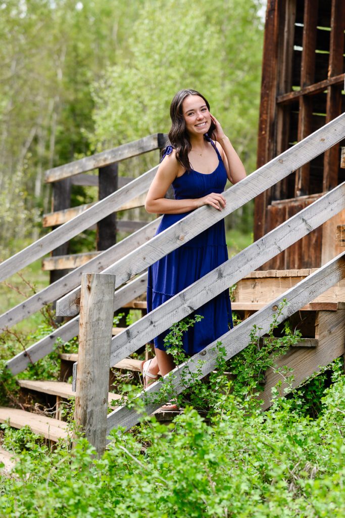 A girl standing on the steps of an old ghost town building in Aspen Colorado for her Colorado Mountain senior photos