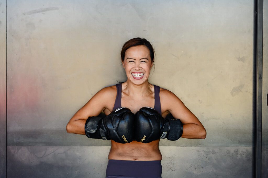 Denver commercial photographer captures athletic woman with boxing gloves on.