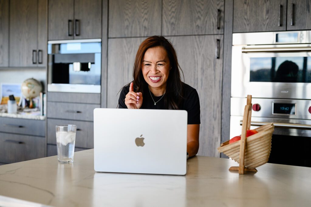 A doctor smiles at her computer for her Denver branding photos.