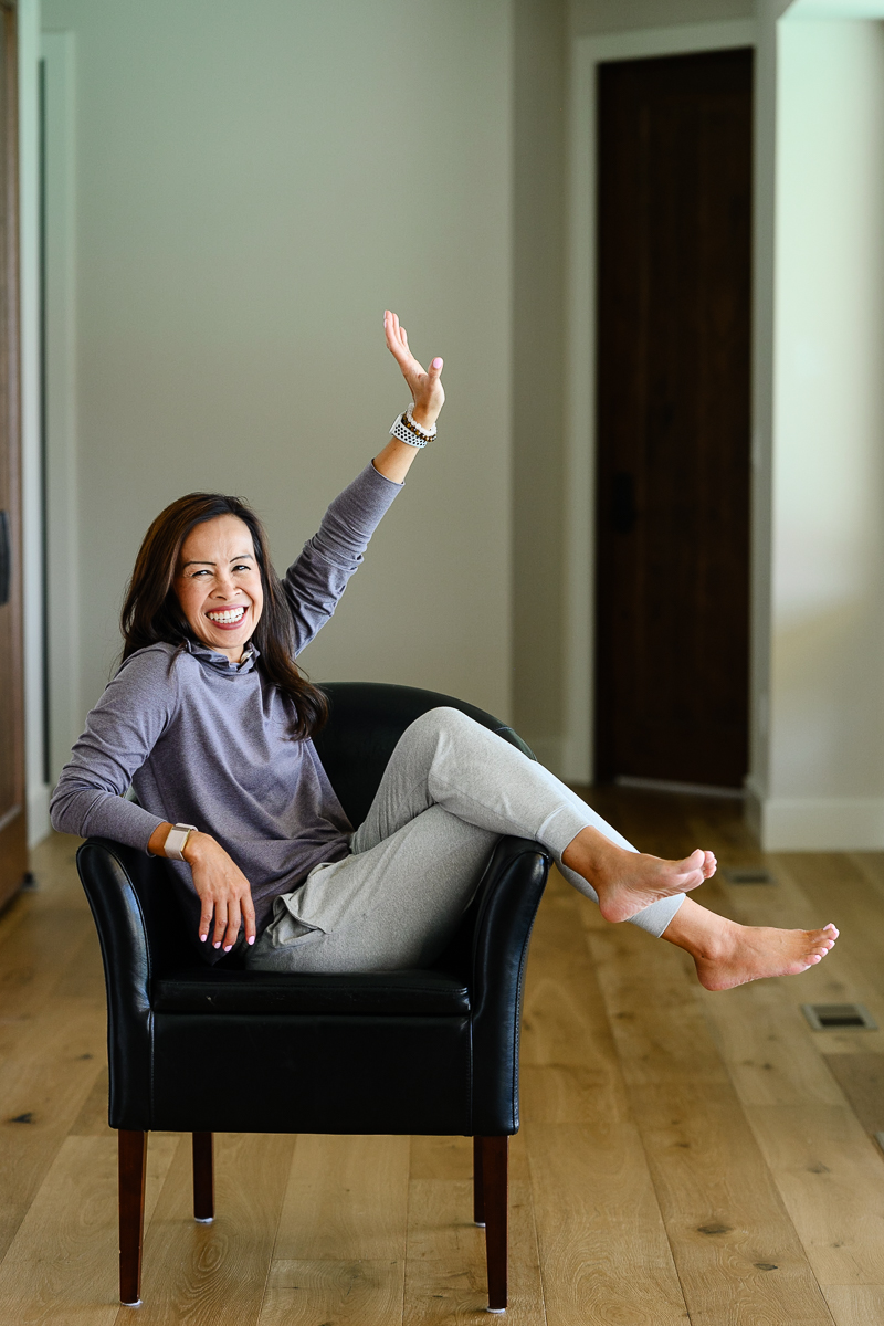 A woman celebrates while smiling at a Denver Commercial Photographer