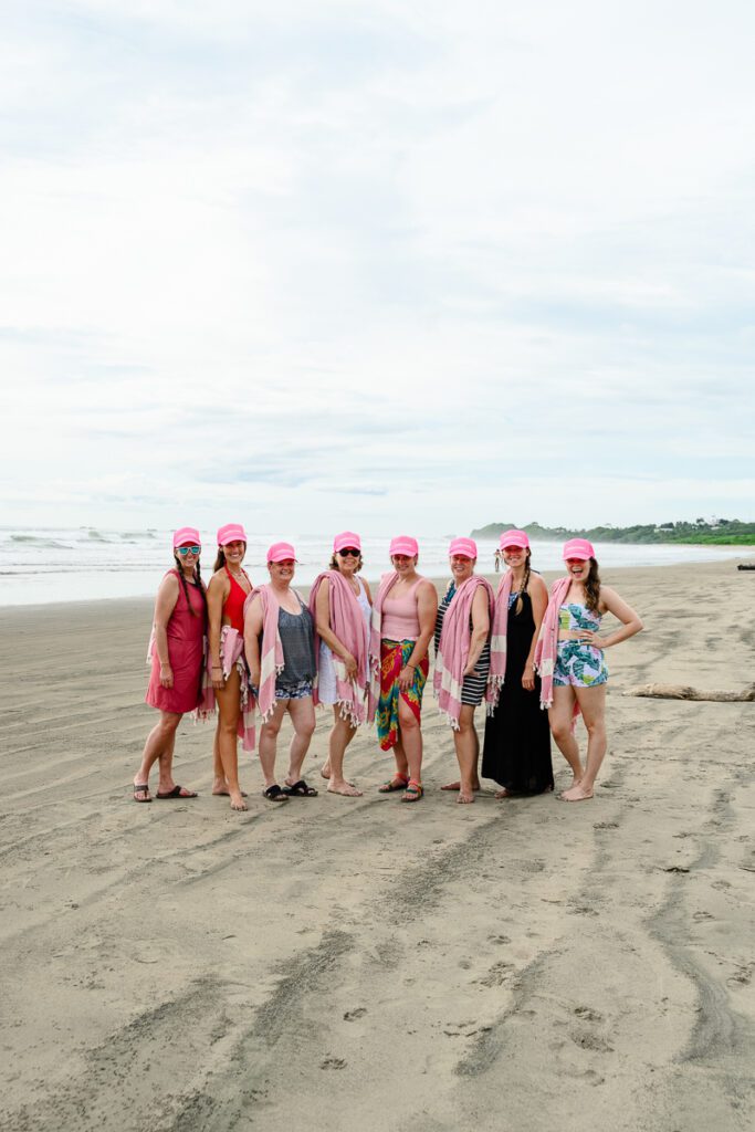 A group of woman standing on the beach in Costa Rica for a branding strategy coach and business retreat.