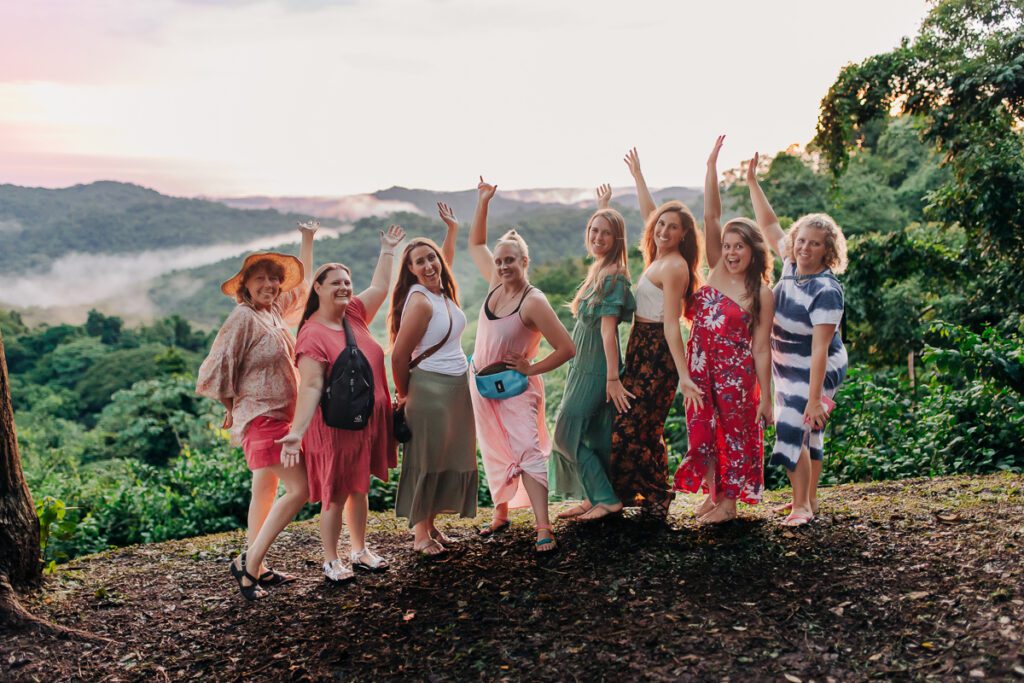 A group of woman in Costa Rica smiling at a Denver Branding photographer and brand strategist.