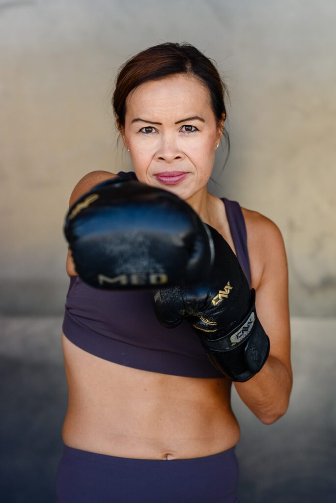 A Denver branding photographer captures a doctor that is in workout gear with boxing gloves.