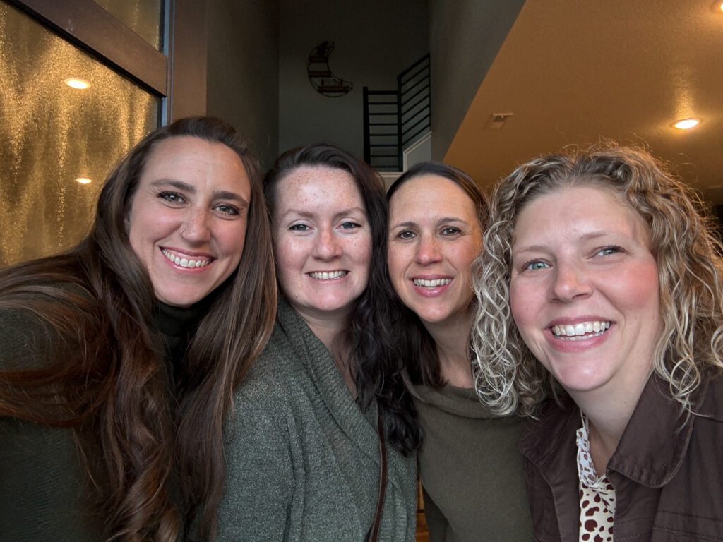 4 women small business owners take a selfie at a business retreat for their Christian businesses as captured by a Denver branding photographer.