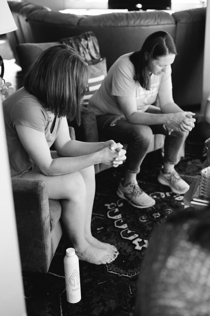 Women praying at a business retreat for Christian small business owners as captured by a Denver branding photographer and brand coach.
