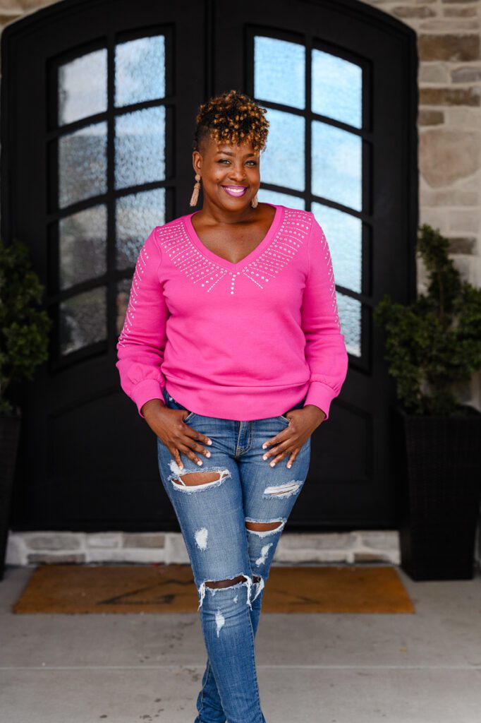 Denver commercial photographers capture a stunning black woman in a bright pink sweater for her Denver Branding photos and Denver Branding photography.