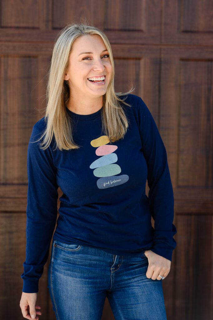 A blonde small business owner standing and smiling at a Denver branding photographer and brand strategist.