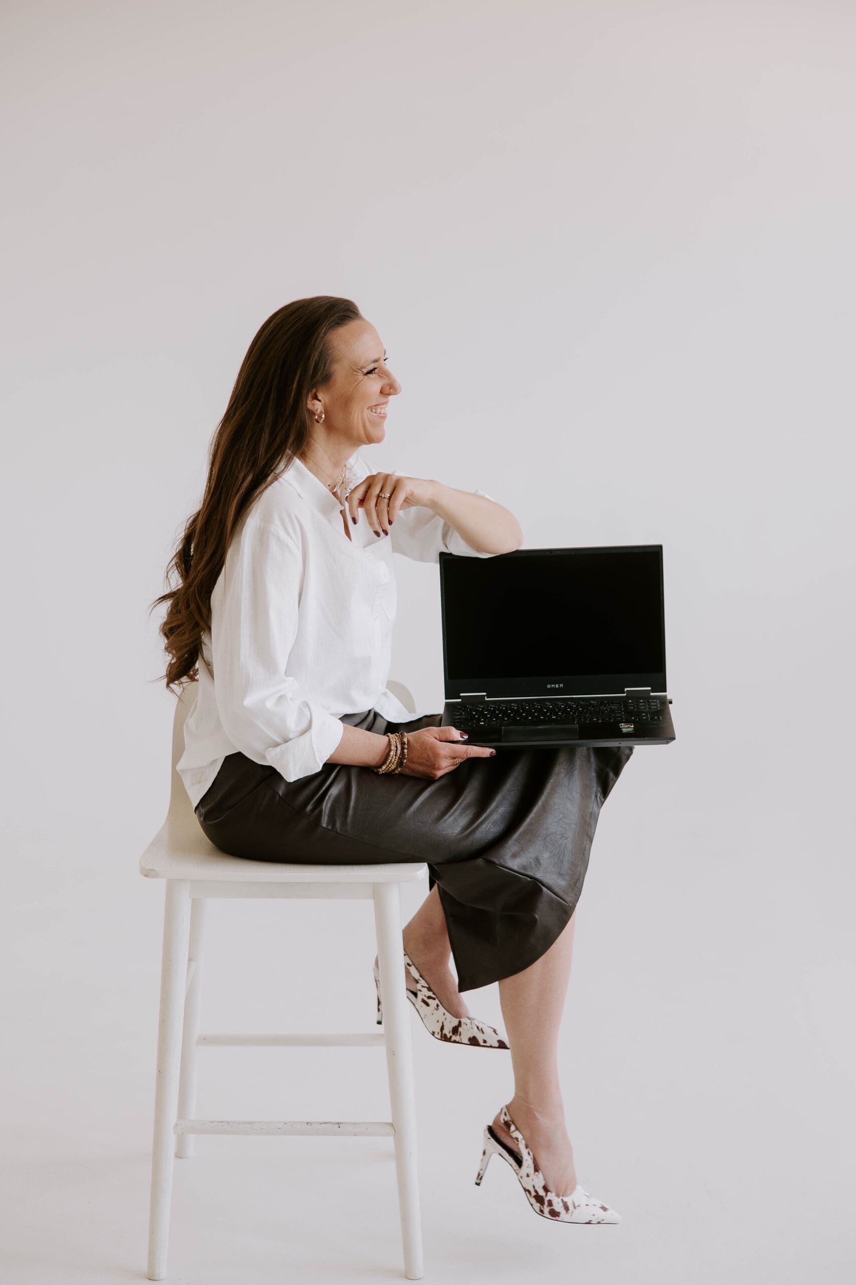 denver commercial photographer captures authentic brand image of woman working at her laptop in a studio space